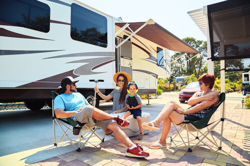 A family tailgating outside their RV.